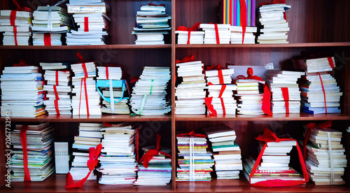 Fotografija Wooden Shelves with Thousands of Neatly Arranged Books and Red Ribbons