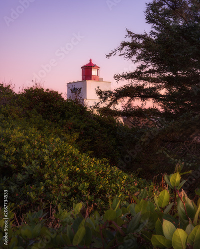 Amphitrite Point Lighthouse at twilight with pink sky, Ucluelet, Vancouver Island