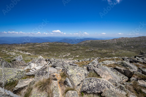Breathtaking views from top of Mount Kosciuszko during a clear day, showcasing vast alpine landscapes and rugged terrain, Australia