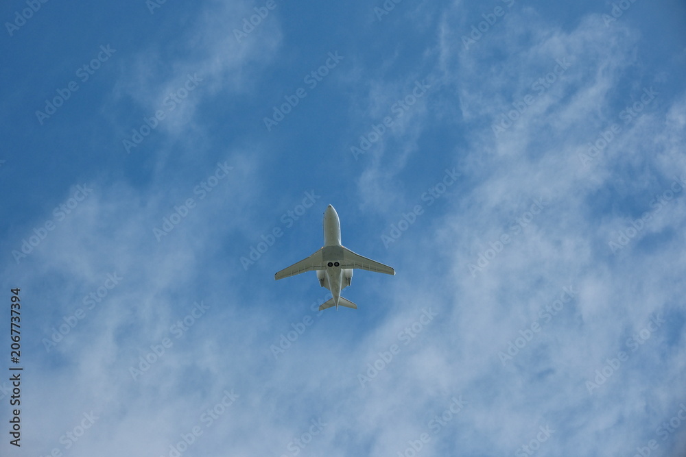 Naklejka premium White Private Jet Climbing in Blue Sky After Takeoff
