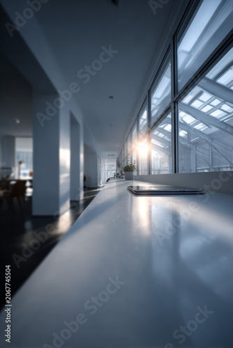 Close up of a closed laptop on a bright white surface with soft morning light and copy space
