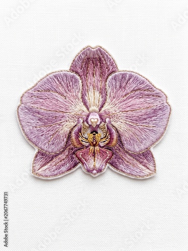 Detailed embroidery purple orchid flower patch isolated on white background
