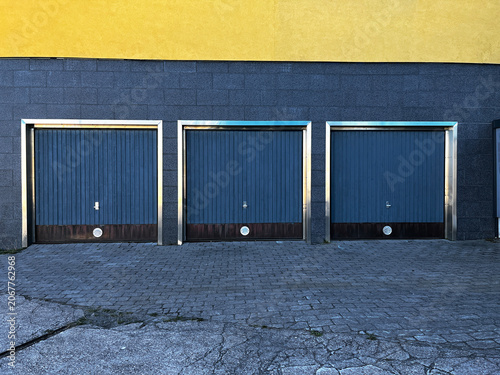 Three of Closed Sectional Garage Gates in Modern Building Outdoor.