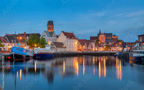 Wismar, Germany - panoramic view of city skyline from Old Port (Alter Hafen) at dusk