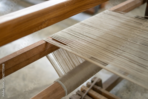 Obraz na plátně Macro shot of a traditional wooden loom with stretched threads