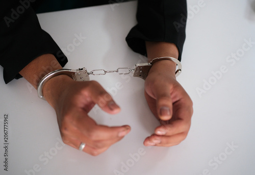Tableau sur toile Business woman with handcuffs on a white background