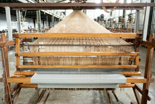 Obraz na plátně Front wide view of a semi-mechanized traditional loom with punched pattern cards and stretched warp threads