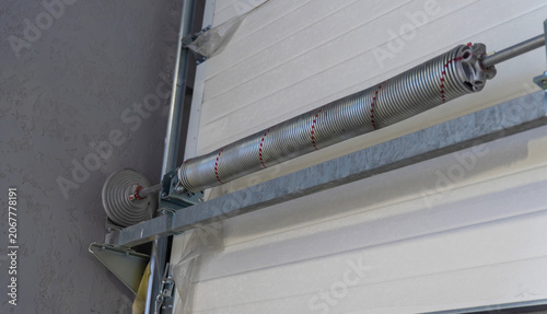 Schilderij op canvas Torsion spring mechanism on sectional garage door