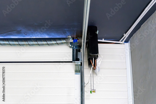 Quadro su tela Automatic electric opener on white sectional garage door mechanism