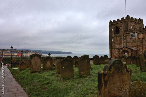 Historic St Mary's Church and Graveyard in Whitby, North Yorkshire; heritage tombstones in cliffside churchyard overlooking Whitby Harbour and North Sea, famous gothic landmark inspiration for Dracula