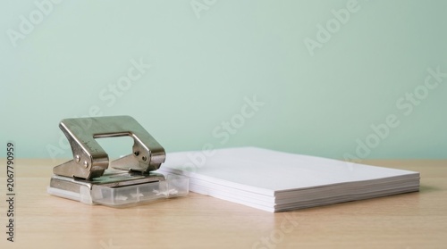 Stack of Coins and Notepad on Wooden Surface for Financial Planning and Budgeting.