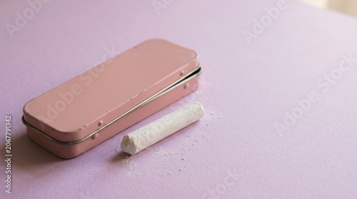 Elegant Pink Pencil Case with White Pen on Light Surface.