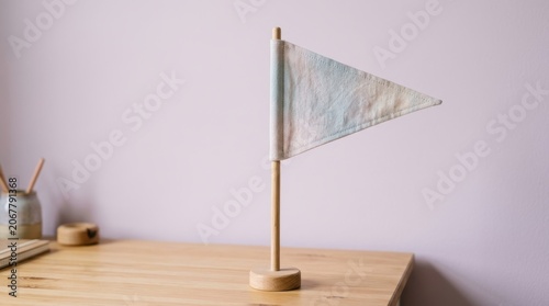 Minimalist White Flag on Wooden Surface for Decoration or Signaling.