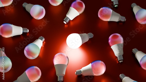 Tableau sur toile Different light bulbs are scattered on a red surface