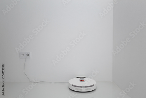 Vacuum cleaner on white glass ceramic tile floor