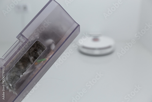 Vacuum cleaner on white glass ceramic tile floor