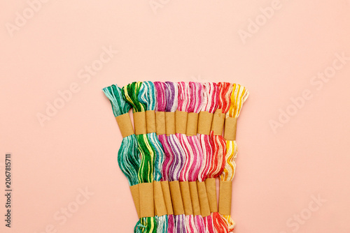 Принти на полотні colorful embroidery floss skeins arranged by color on a soft pastel background