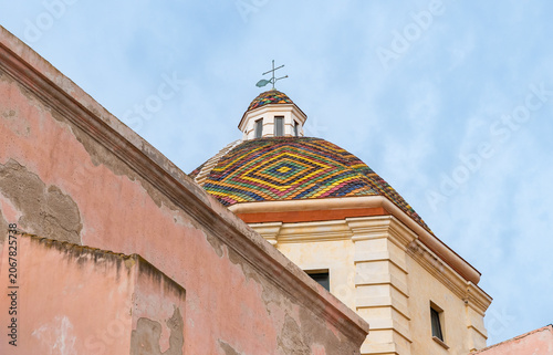 The colorful tiled dome of the Church of San Michele in the historic center of Alghero, Sardinia, Italy. 