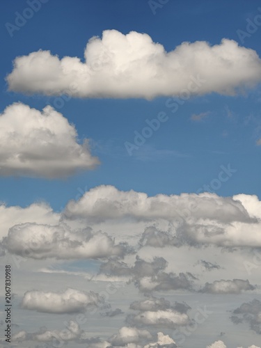 Scattered Cumulus Clouds Floating in Clear Blue Sky