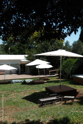Relaxing Outdoor Lounge Area with Umbrellas and Garden Cushions at a Resort