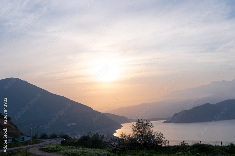 Obraz premium Sunset over Charvak reservoir in the mountains. Concept: Mountain lake landscape at dusk