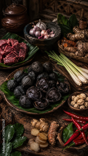 Rawon ingredients with kluwek nuts, spices, herbs, chilies, and dark beef soup components .generative AI