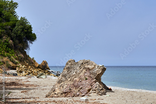 A boulder on the rocky coast of the Aegean Sea, Greece