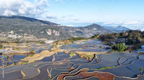 Aerial time-lapse view of the Yuanyang terraced fields with the reflection of mountains in the water