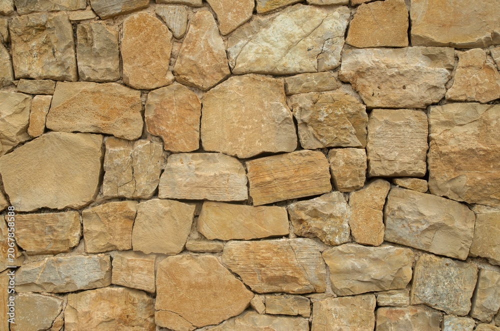 Fototapeta premium Yellow stone wall close up