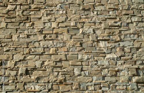 New yellow relief stone tiles on wall closeup