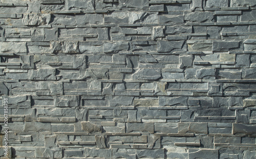 New gray relief stone tiles on wall closeup