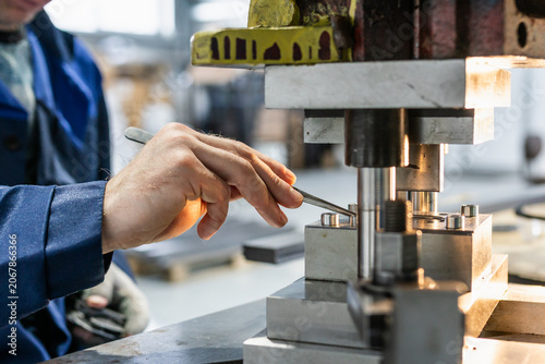 Industrial press mold in operation, precision metal forming equipment inside manufacturing workshop, focus on factory production process