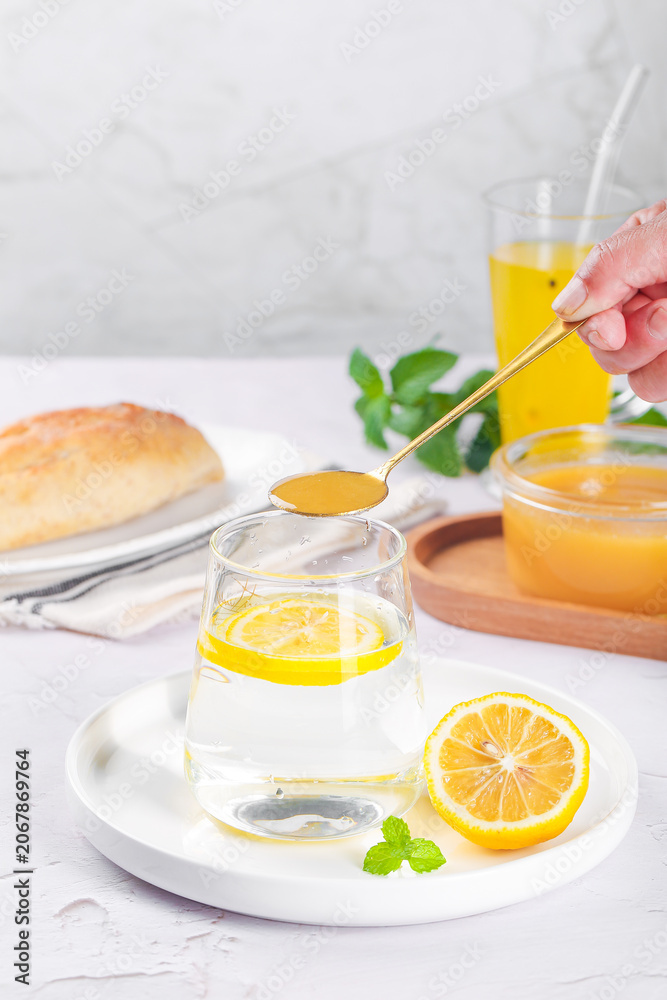 Fototapeta premium Crystallized Honey and Lemon Water with Fresh Flowers and Mint