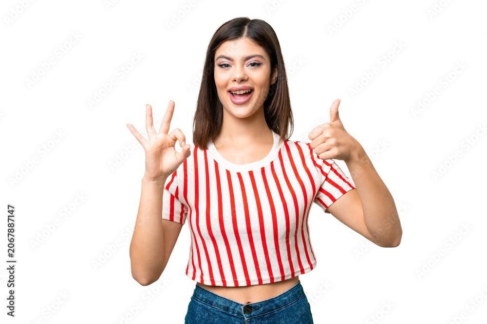 Naklejka premium Young Russian woman over isolated chroma key background showing ok sign and thumb up gesture