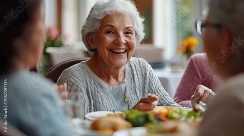 Close up portrait of a smiling senior woman enjoying a meal with friends