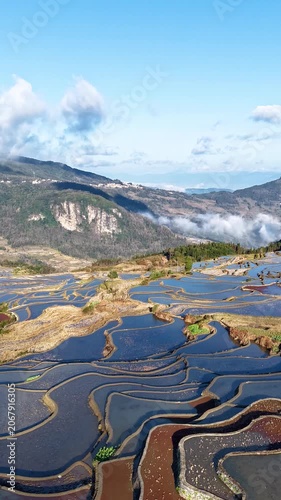 Aerial time-lapse view of the Yuanyang terraced fields with the reflection of mountains in the water