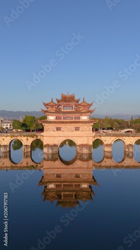 Aerial view of the sunrise reflection on the Seventeen-Hole Bridge in Jianshui, Yunnan