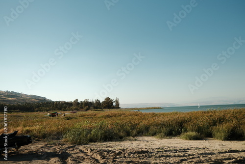 Expansive Panoramic View of the Tranquil Sea of Galilee Shoreline Under a Clear Summer Sky in Northern Israel