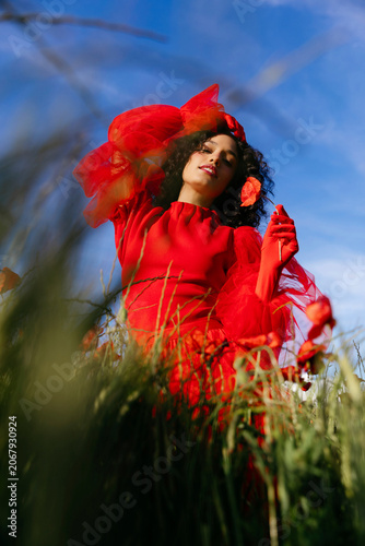 Woman picking poppies in summer field