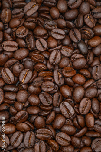 Vertical full frame texture background of dark roasted coffee beans.