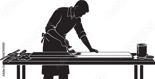 Man applying paste to paper on table with tools and can black