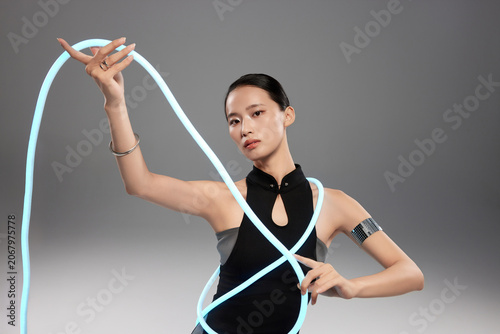 Futuristic Woman Posing with Glowing Cable