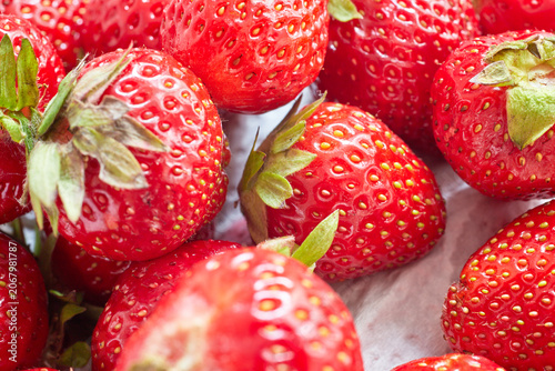 Fresh ripe strawberries placed on a white napkin.