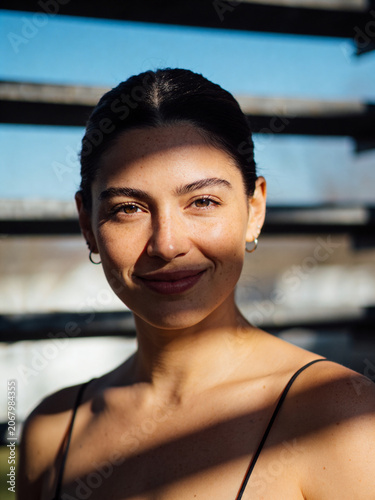 Summer sunny portrait of a young person in natural light, warm outdoor atmosphere with a bright seasonal mood and relaxed lifestyle feeling