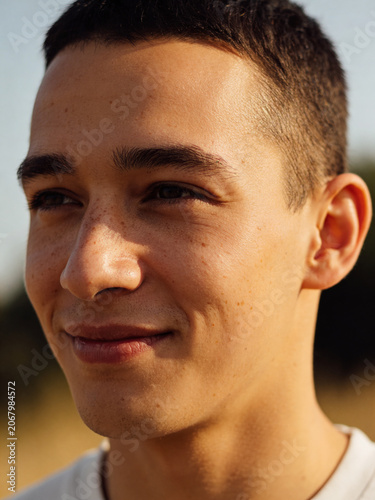Summer sunny portrait of a young person in natural light, warm outdoor atmosphere with a bright seasonal mood and relaxed lifestyle feeling