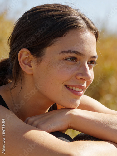 Summer sunny portrait of a young person in natural light, warm outdoor atmosphere with a bright seasonal mood and relaxed lifestyle feeling