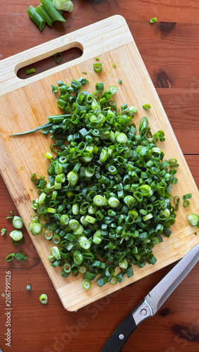 Fresh Chopped Green Onions on Wooden Cutting Board, Top View