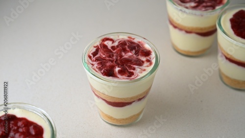 Cuadro en lienzo Homemade cottage cheese (farmers cheese) dessert cups layered with vanilla cookie crumbs and strawberry confit sauce