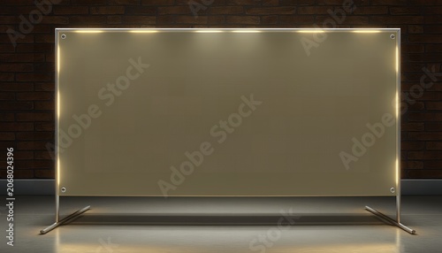 A large rectangular lighted sign with a blank beige surface stands on a metal frame in a dark room with brick walls