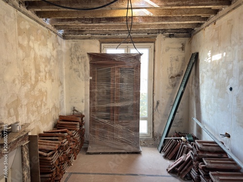Room under renovation with furniture covered